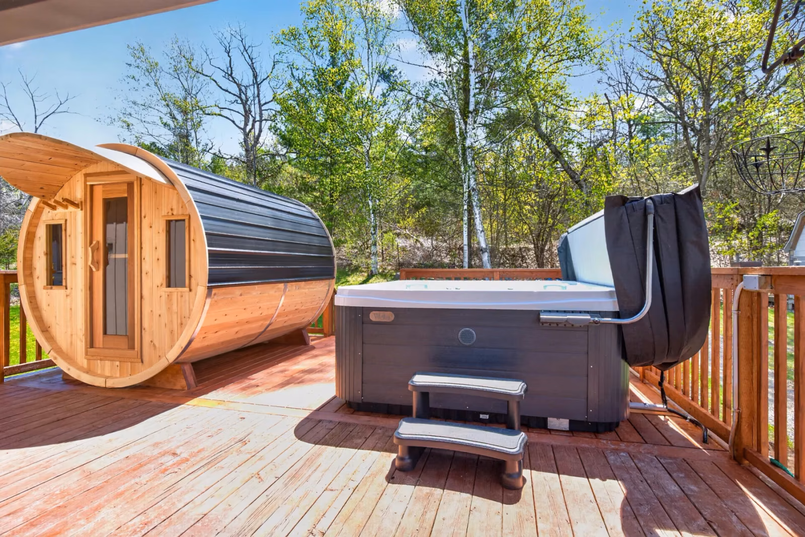 Outdoor hot tub and barrel sauna on the wellness deck
